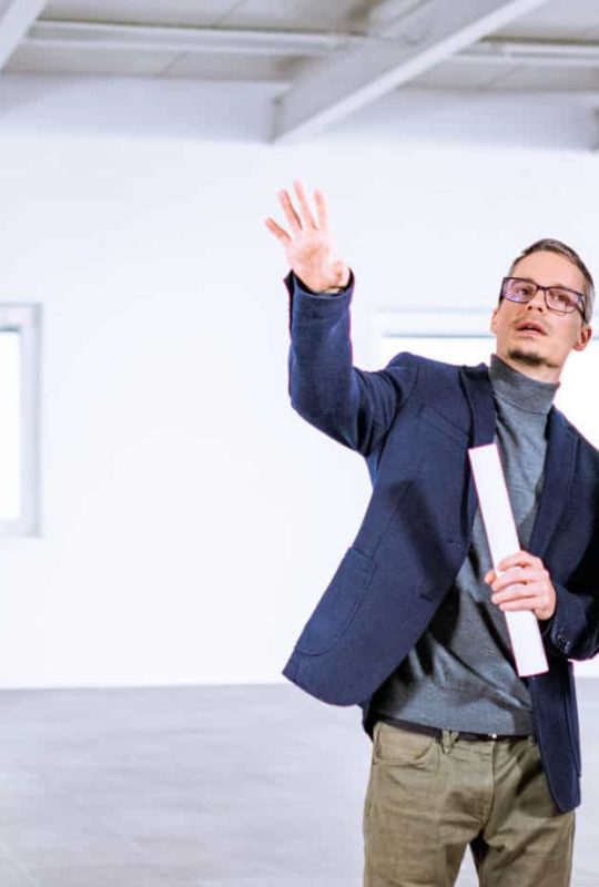 Real estate agent talking to entrepreneur in an empty office building