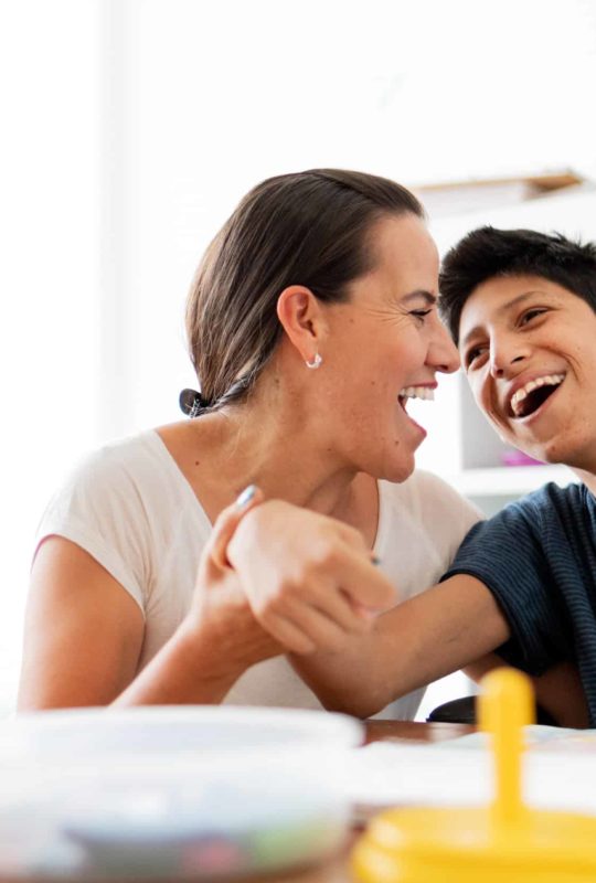 Mother playing with son with Cerebral Palsy